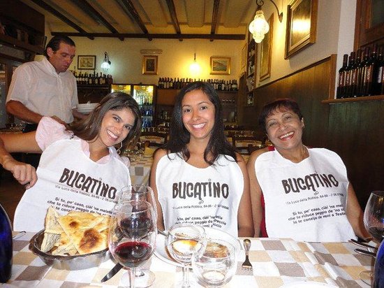 Three women wearing bibs from Trattoria da Bucatino