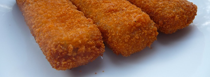 Three fish fingers on a plate