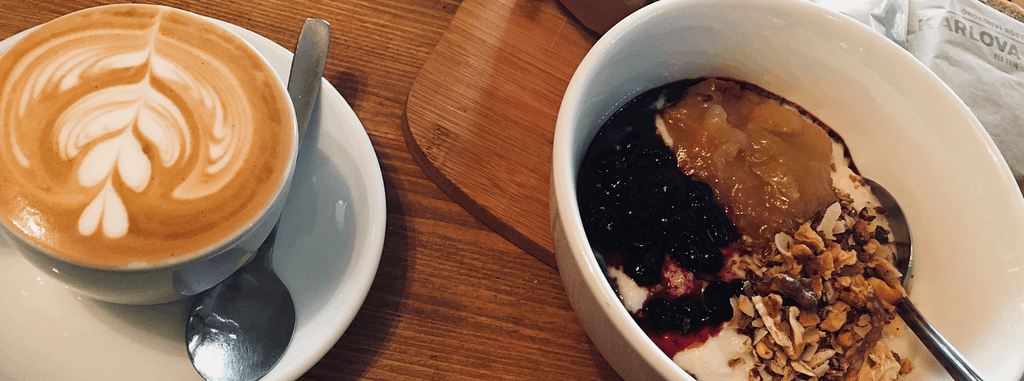 Bowl of porridge and cappucino